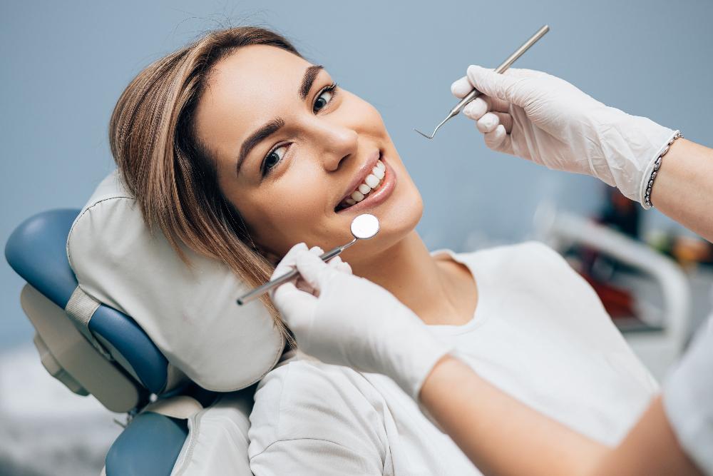 woman smiling in exam chair | dentist west chester