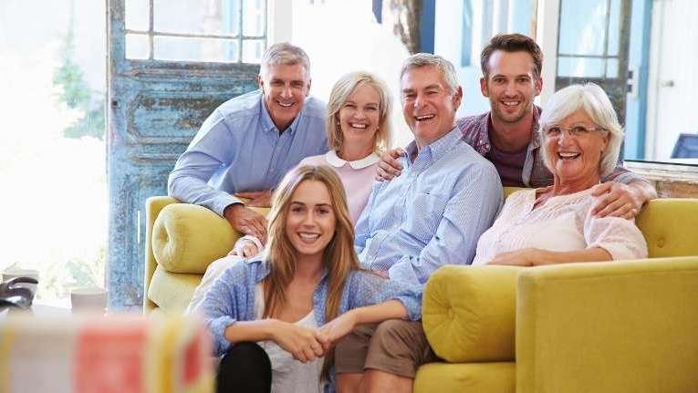large family sitting on couch | west chester oh dentist