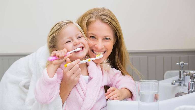 Mother and daughter doing a toothbrush