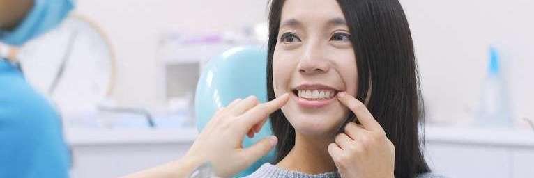 woman sitting in dentist exam chair | dentist near me